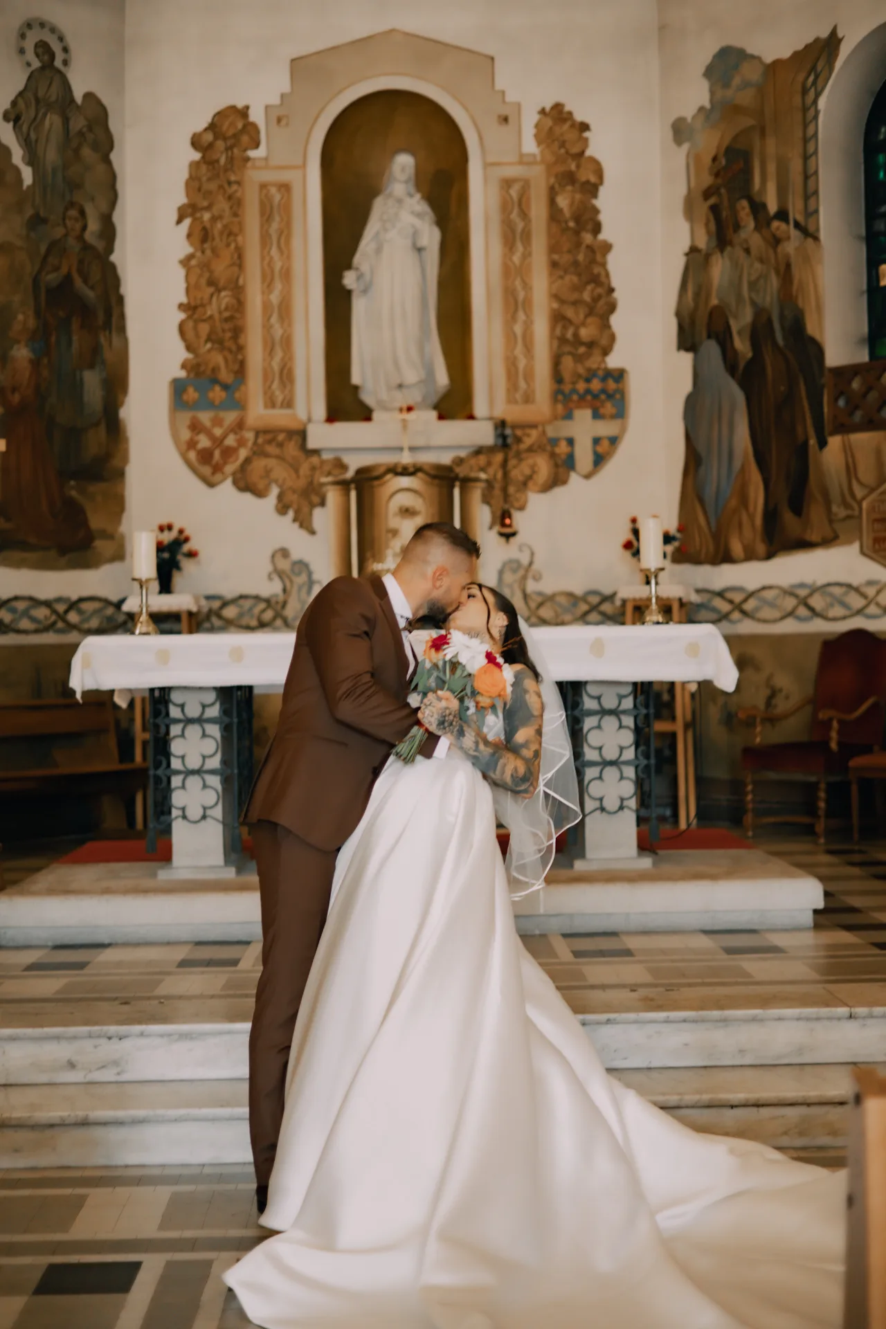Le baiser des mariés devant l'autel d'une église